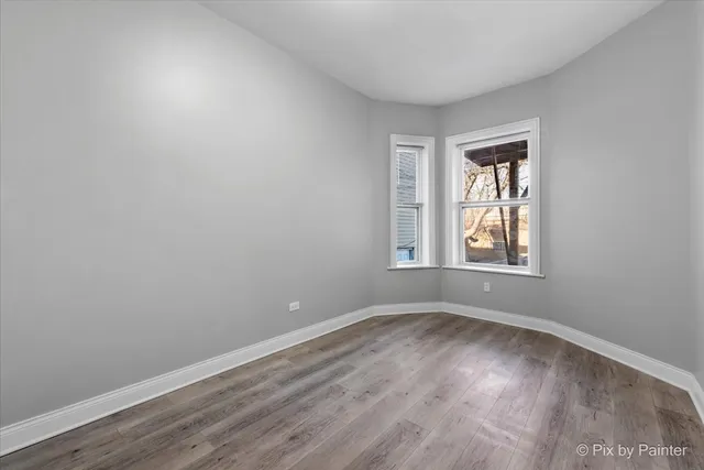 a bathroom with a granite countertop toilet a sink and a window
