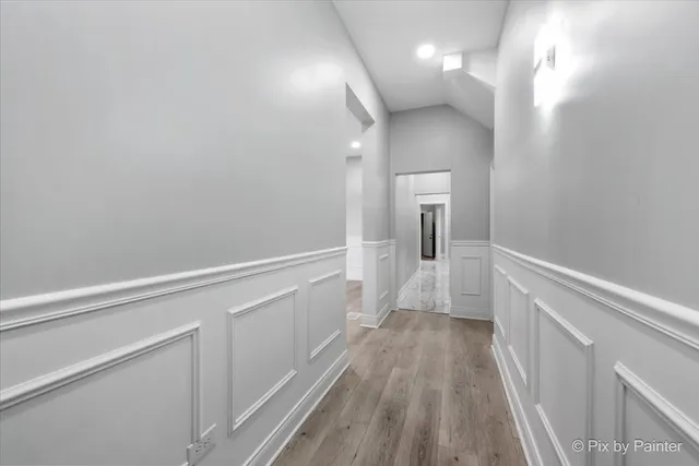 a view of a room with wooden floors and white walls