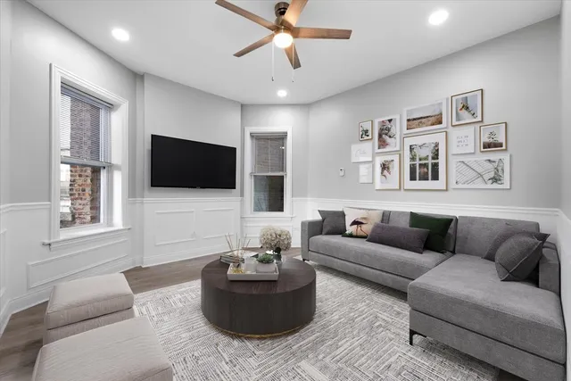 a bedroom with a bed and a lamp on dresser
