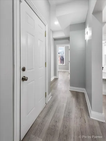 a view of a hallway with wooden floor