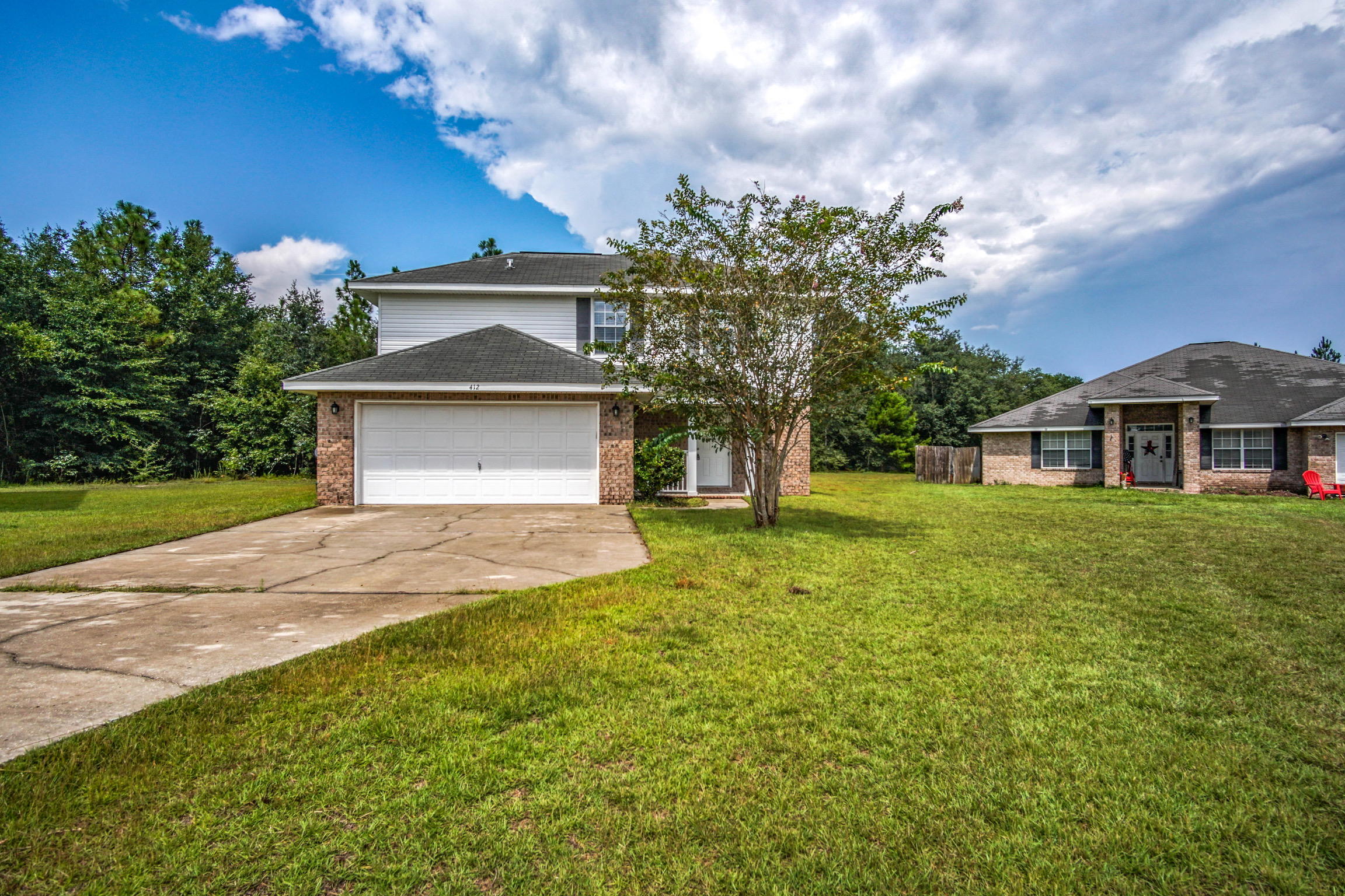 412 Plate Drive Crestview, FL 32539 - Photo 1 of 25 a front view of a house with a yard and garage