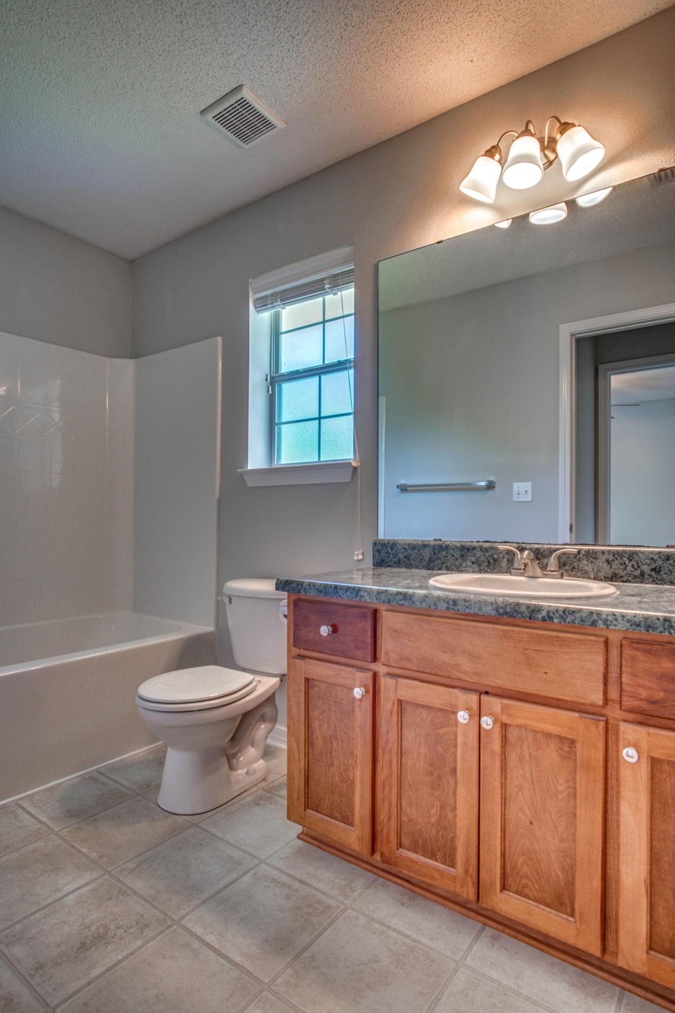 412 Plate Drive Crestview, FL 32539 - Photo 14 of 25 a bathroom with a toilet a sink and bathtub