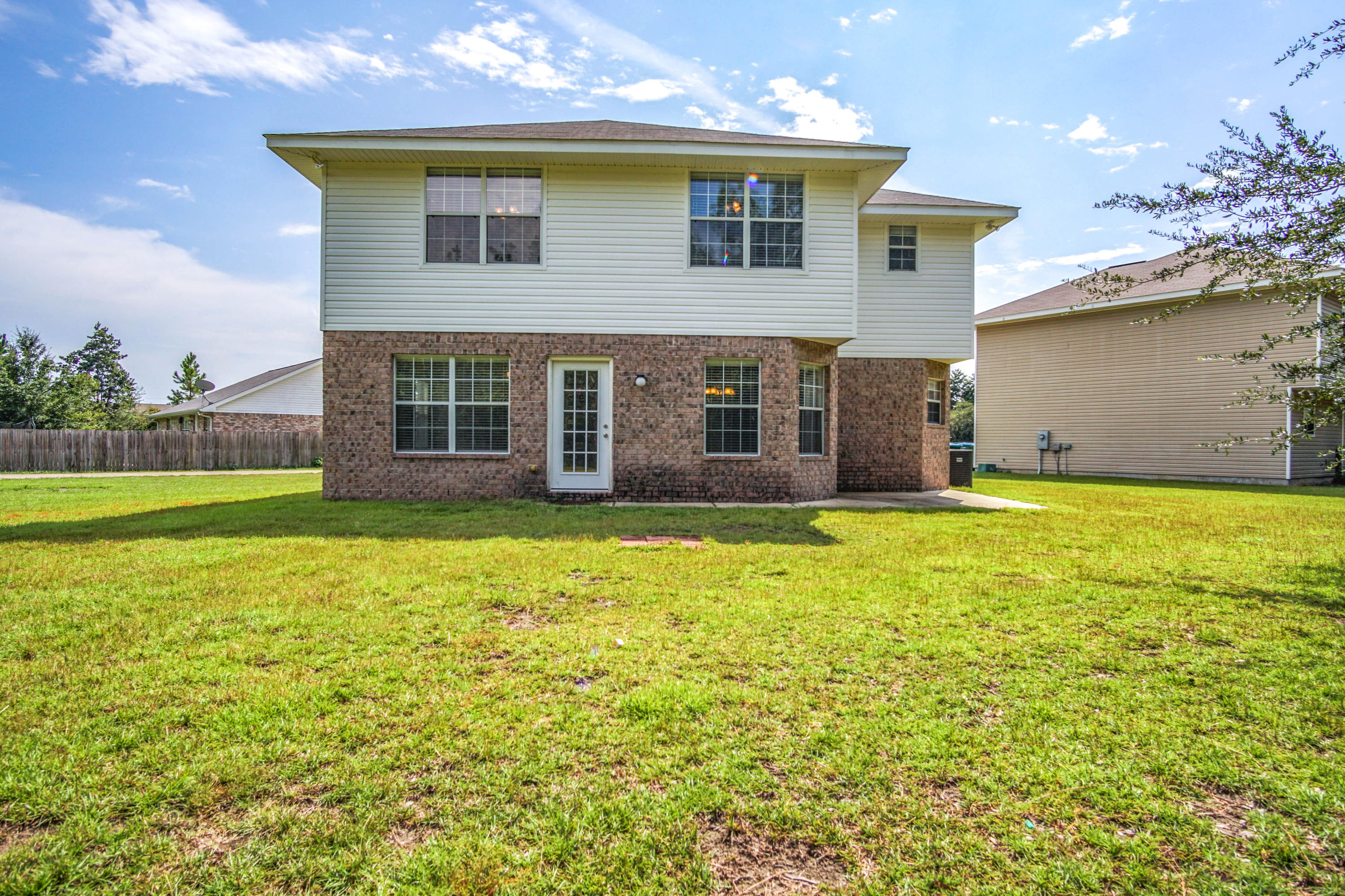 412 Plate Drive Crestview, FL 32539 - Photo 22 of 25 a view of a house with a yard