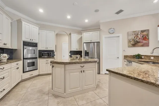 a kitchen with granite countertop a sink counter top space appliances and cabinets