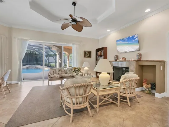 a dining room with furniture a chandelier and window