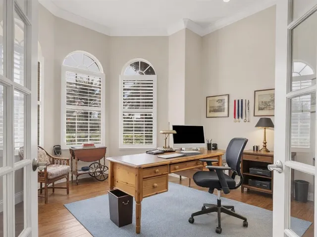 a view of a livingroom with workspace and a window