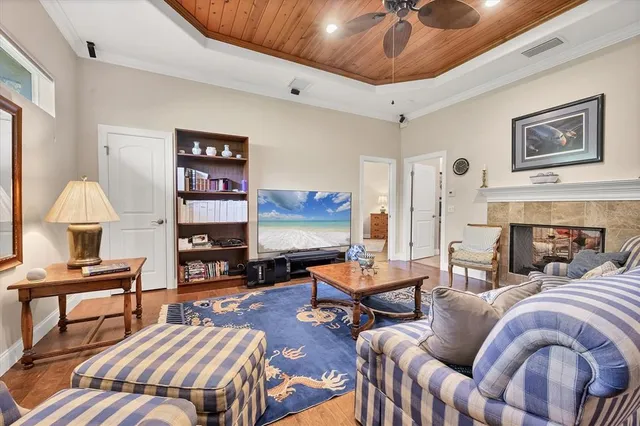 a living room with furniture a fireplace and a flat screen tv