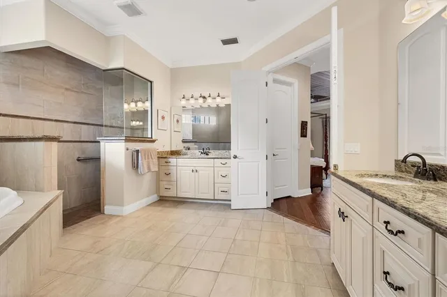 a large white kitchen with a stove a sink dishwasher and a refrigerator