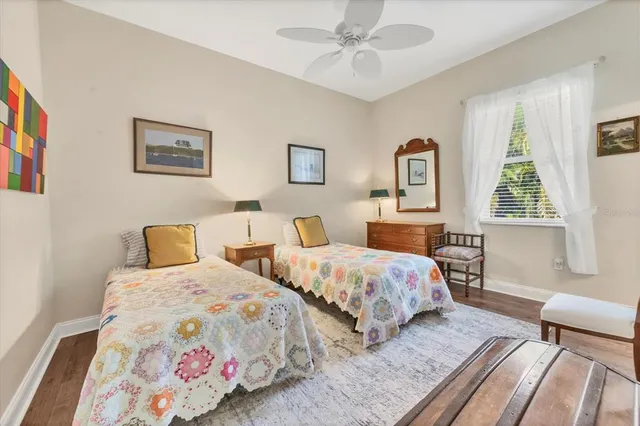 a bedroom with two beds and a window