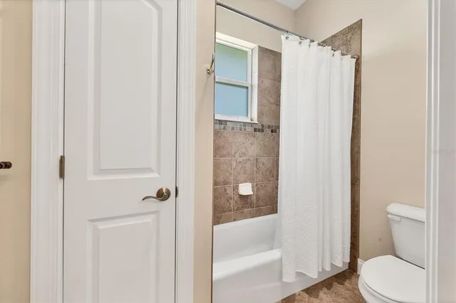 a bathroom with a shower and a toilet