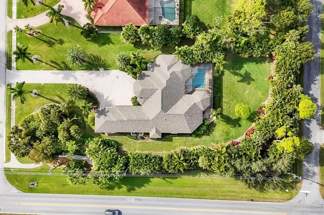 an aerial view of a house with a yard and garden