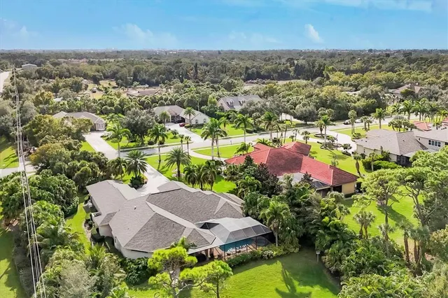 an aerial view of a house with a lake view