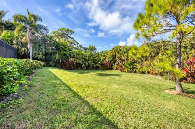 a view of yard with swimming pool and green space