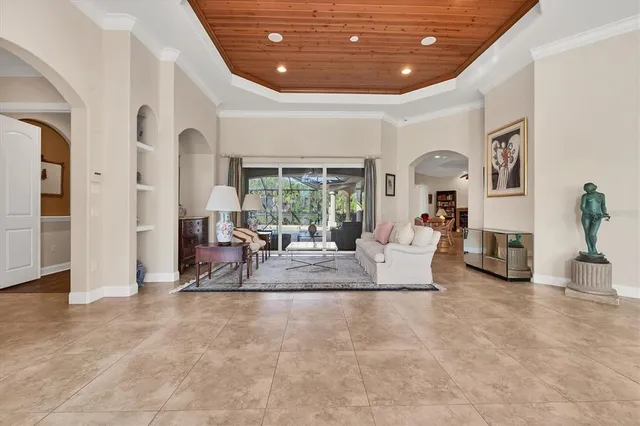 a living room with furniture and a chandelier