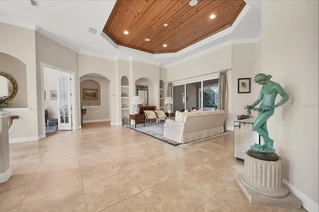 a living room with furniture and a chandelier