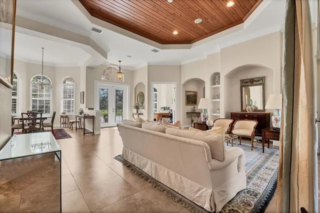 a living room with furniture and a large mirror