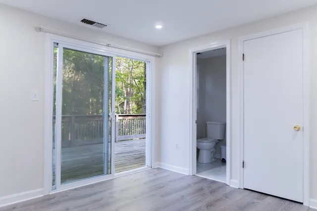 a bathroom with a glass door shower and a sink