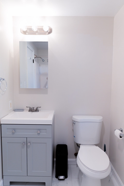 24 Little John Road Falmouth, MA 02536 - Photo 14 of 34 a bathroom with a toilet a sink and mirror