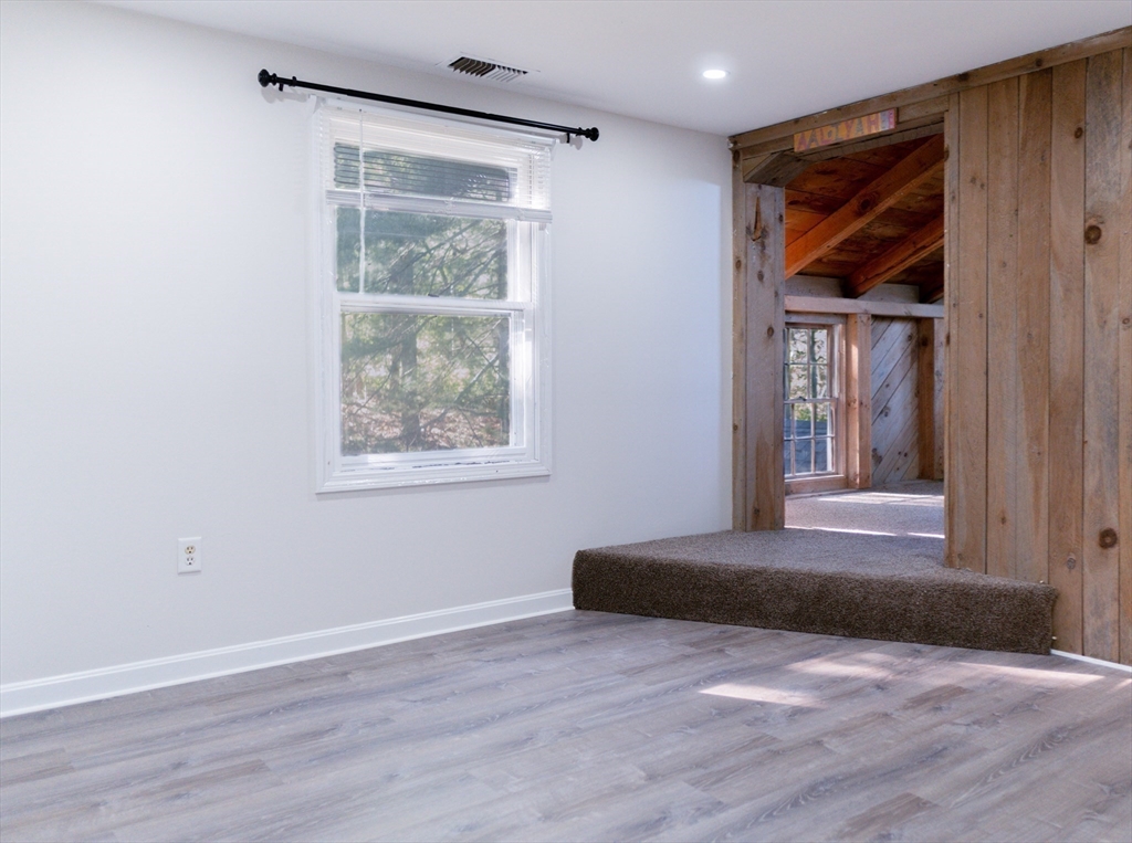 24 Little John Road Falmouth, MA 02536 - Photo 16 of 34 an empty room with wooden floor and windows