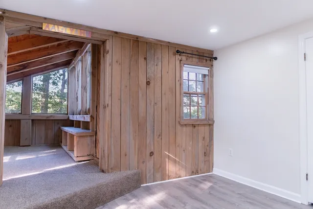 a view of empty room with furniture and window