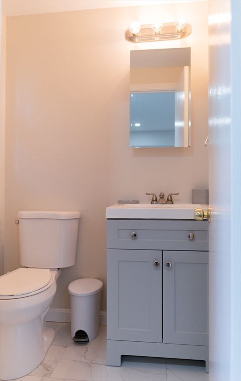 24 Little John Road Falmouth, MA 02536 - Photo 19 of 34 a bathroom with a toilet a sink and mirror