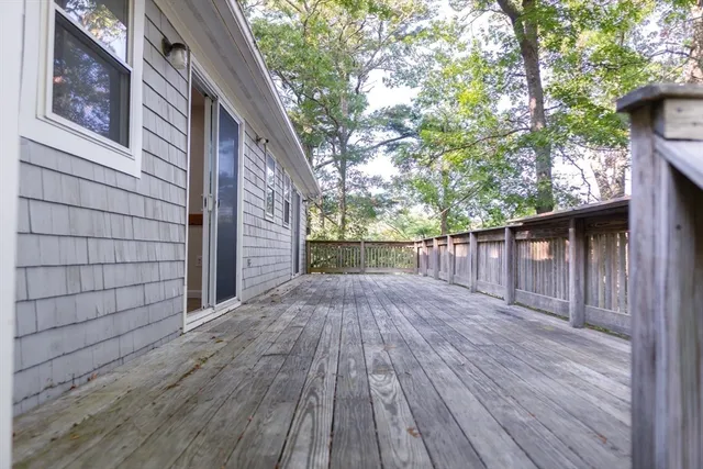 a balcony with wooden floor and fence