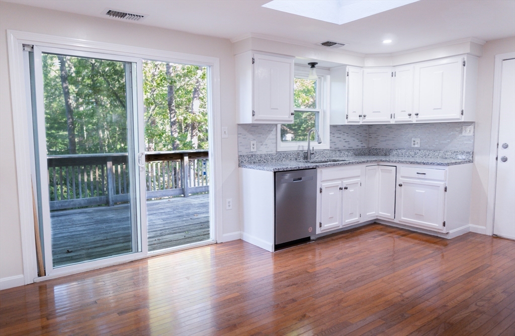 24 Little John Road Falmouth, MA 02536 - Photo 5 of 34 a kitchen with wooden floors and sink