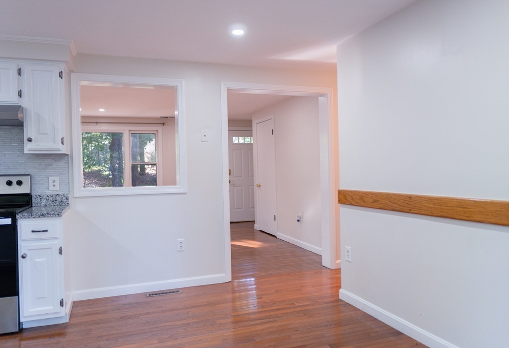 24 Little John Road Falmouth, MA 02536 - Photo 7 of 34 a view of an empty room with wooden floor and a window