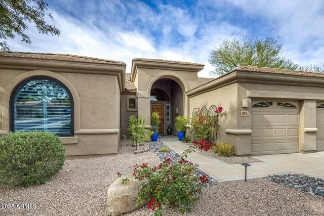 a front view of a house with a garden