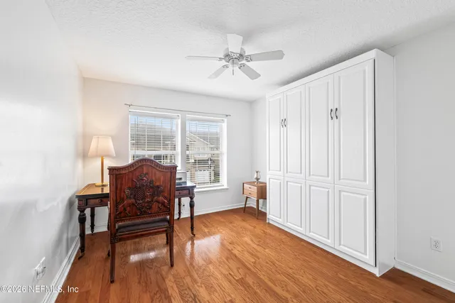 a view of a livingroom with furniture and hardwood floor