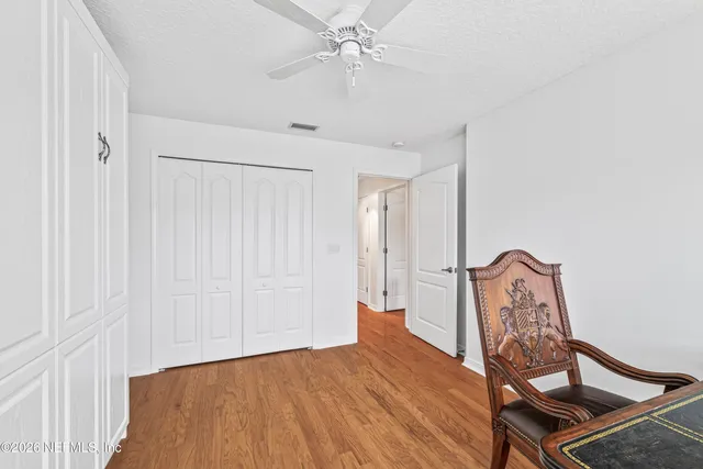 a view of a room with wooden floor and entryway