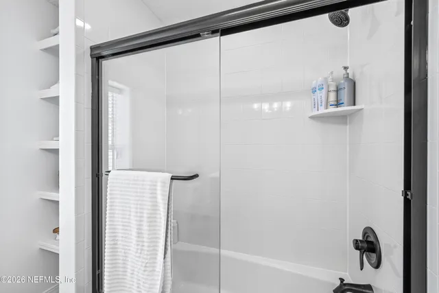 a bathroom with a glass shower door