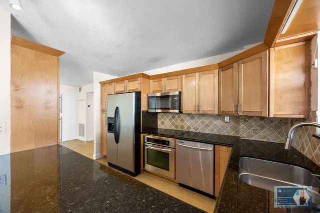 a kitchen with a refrigerator and a sink