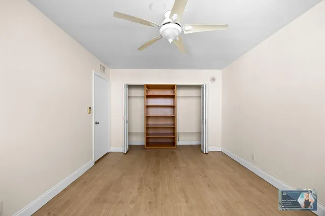 a view of an empty room with a kitchen