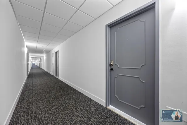 a view of a room with gym equipment and large windows