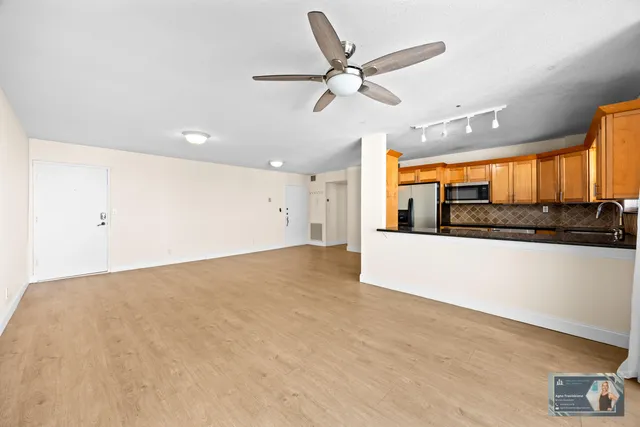 a kitchen that has a sink and a stove in it
