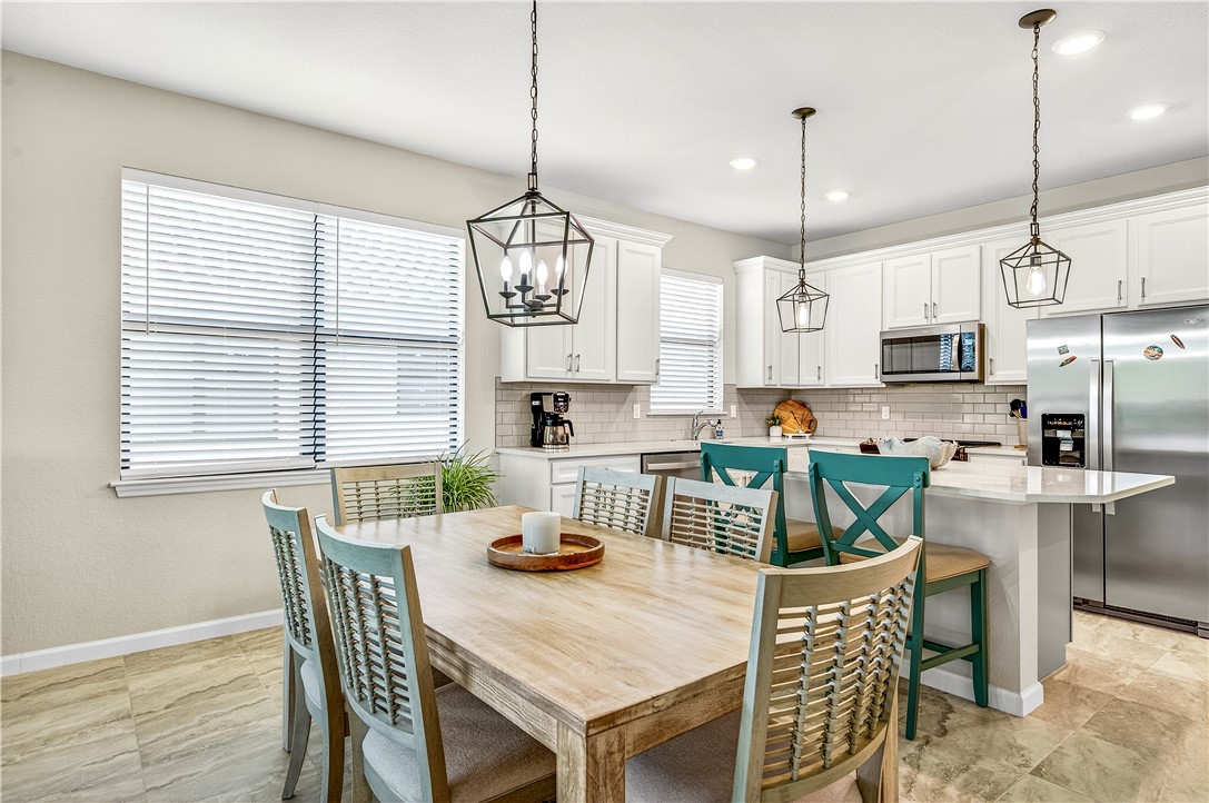 4229 Silver Maple Way Vero Beach, FL 32967 - Photo 14 of 36 a view of a dining room and livingroom with furniture wooden floor and a chandelier