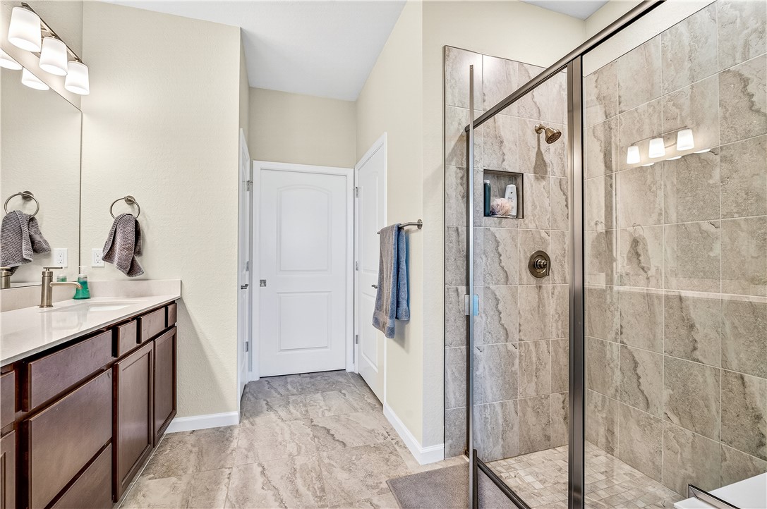 4229 Silver Maple Way Vero Beach, FL 32967 - Photo 19 of 36 a bathroom with a shower sink and mirror