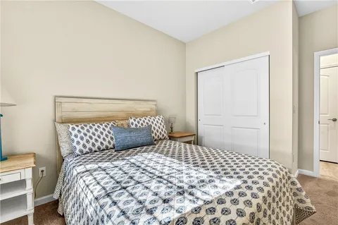 a bedroom with a large bed and a potted plant