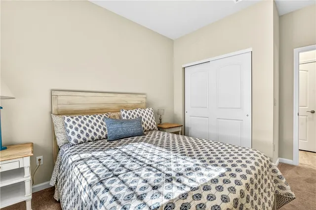 a bedroom with a large bed and a potted plant