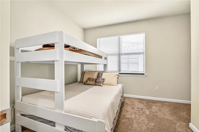 a bedroom with a bed next to a window with a sink