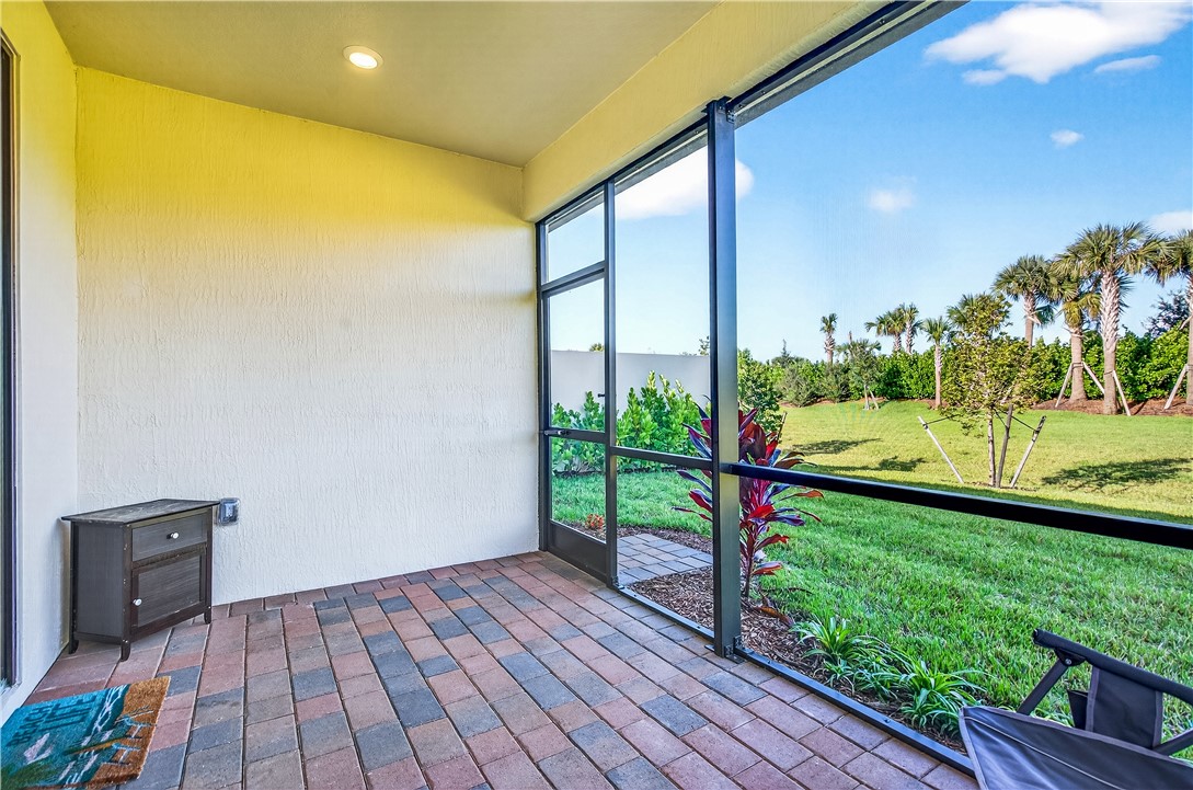 4229 Silver Maple Way Vero Beach, FL 32967 - Photo 27 of 36 a view of a porch with a table and chairs