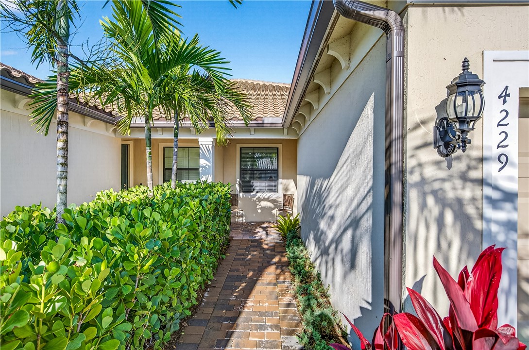 4229 Silver Maple Way Vero Beach, FL 32967 - Photo 29 of 36 a front view of a house with a yard