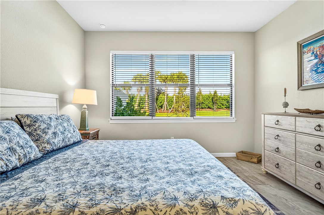 4229 Silver Maple Way Vero Beach, FL 32967 - Photo 6 of 36 a bedroom with a large bed and a window