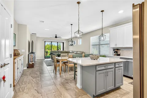a open kitchen with a sink a counter top appliances and cabinets