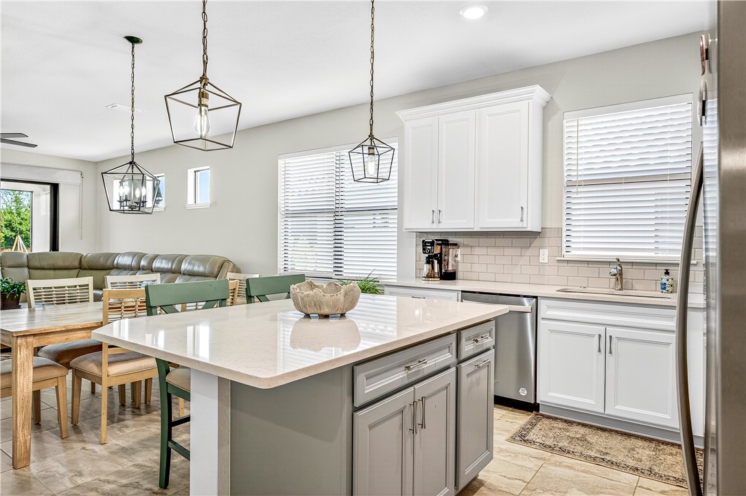 4229 Silver Maple Way Vero Beach, FL 32967 - Photo 8 of 36 a kitchen with a sink a window and chairs