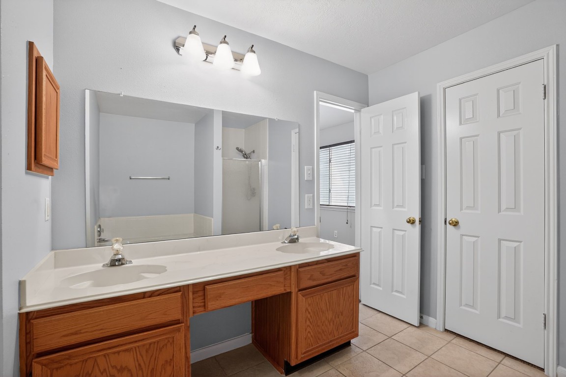 18622 Timbers Drive Humble, TX 77346 - Photo 19 of 34 a spacious bathroom with double vanity sinks a mirror and a shower