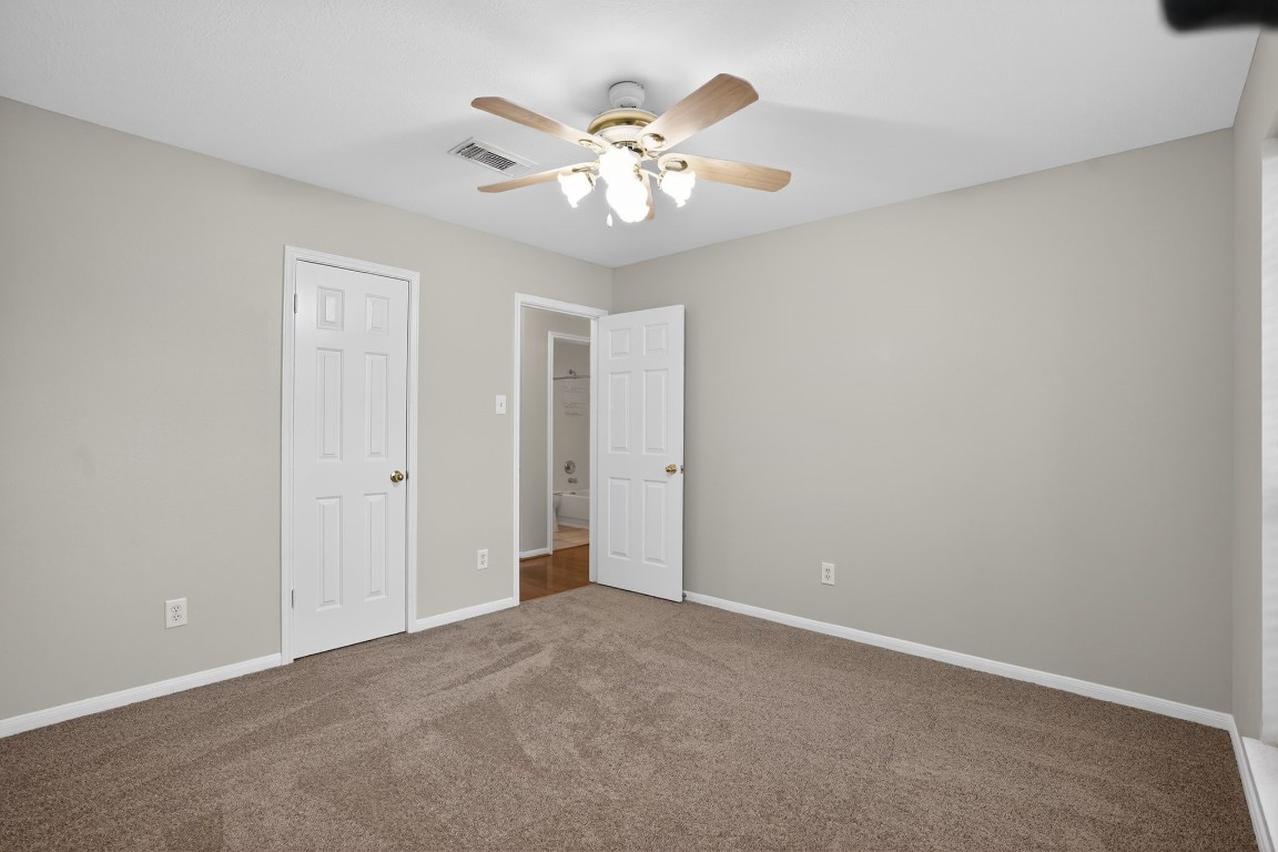 18622 Timbers Drive Humble, TX 77346 - Photo 26 of 34 a view of an empty room with chandelier fan