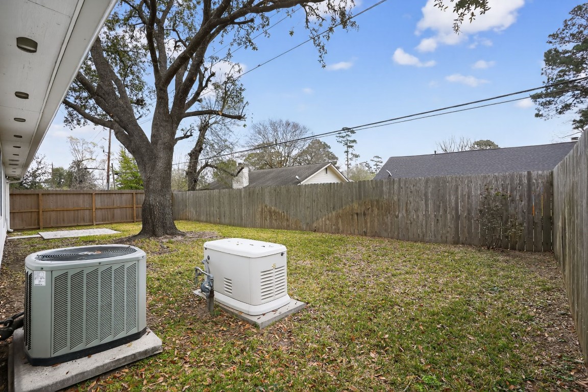 18622 Timbers Drive Humble, TX 77346 - Photo 31 of 34 a view of a backyard with a small cabin and wooden fence