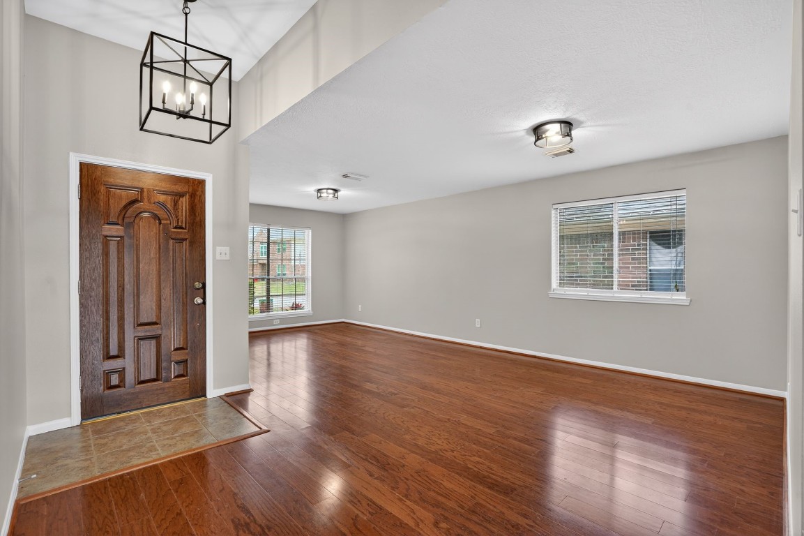 18622 Timbers Drive Humble, TX 77346 - Photo 4 of 34 wooden floor in an empty room with a window